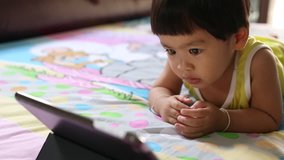 Baby Asian girl see tablet, video HD
