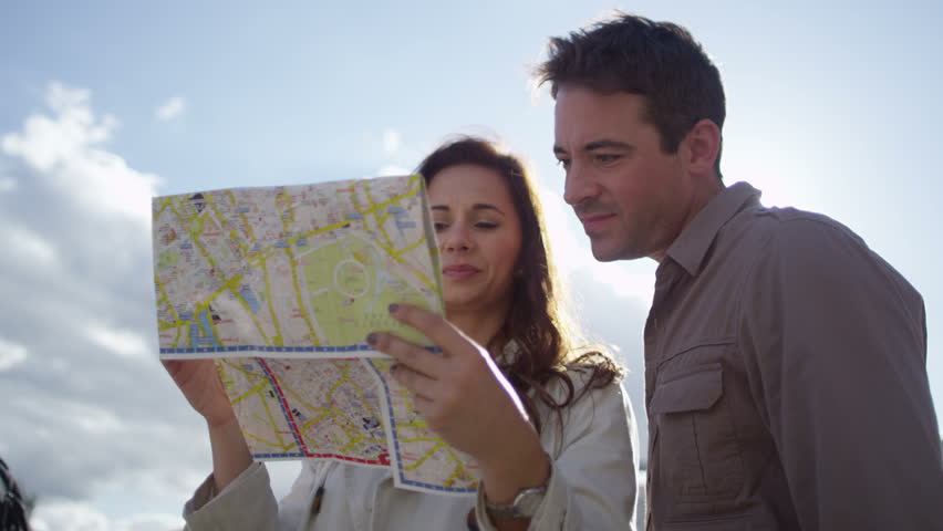 4K Attractive couple sightseeing in London, looking at map in Trafalgar Square. Shot on RED Epic.