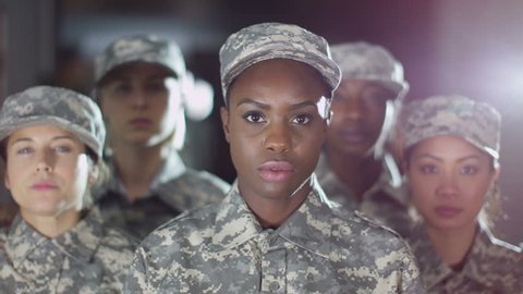 4K Mixed ethnicity female soldiers stand to attention and salute. Shot on RED Epic.