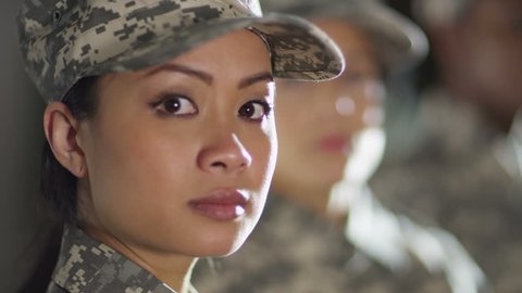 4K Close up on faces of mixed ethnicity female soldiers standing to attention. Shot on RED Epic.