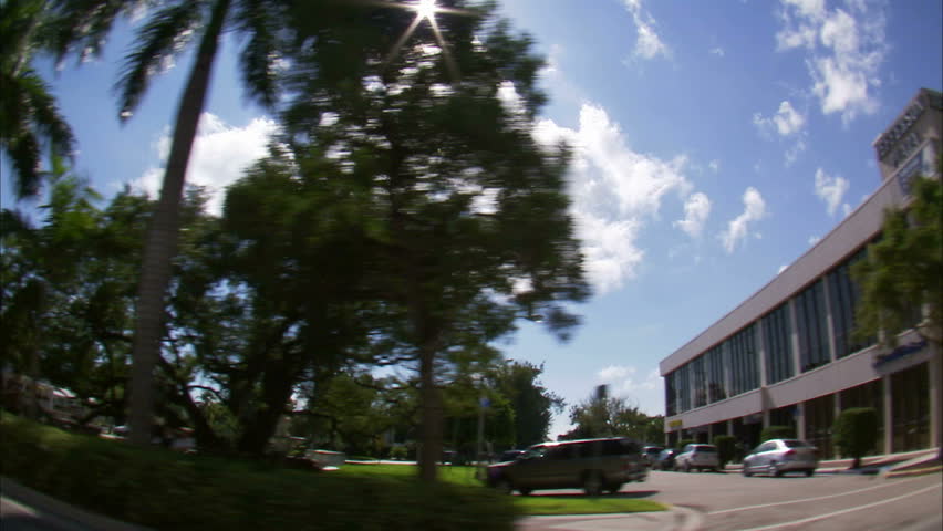 A trucking shot with a wide angle lens passing through a business district in Miami.