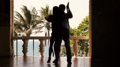 Man and woman, young hispanic couple dancing latin american dance outdoors