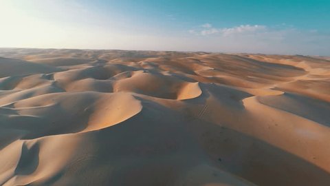 Flying over barren red sandy desert