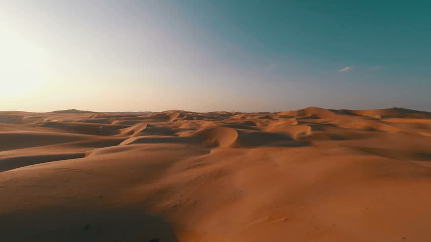 Flying backwards over picturesque sand dunes in the Arabian desert Royalty-Free Stock Footage #12046013