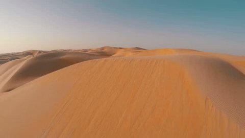 Drone shot flying close over sand dune