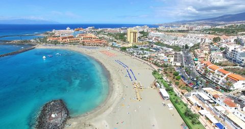 Beautiful aerial flight over Los Cristianos beach (Playa de las America), Canary Island Tenerife, Spain