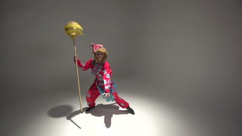 Orange, red monkey symbol 2016, the character in the costume of the Chinese monkey King performs in the Studio in kung fu style, slow motion