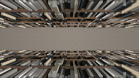 A slow pan across a direct top view of a row of a library bookshelf in a carpeted aisle
