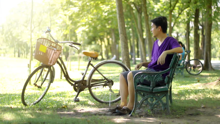 Asian Man drinking water in the park