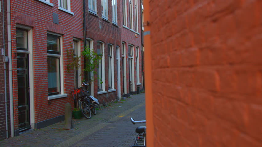 This street is located in the centrum (center) of Haarlem a suburbs of Amsterdam Holland Netherlands. It features red brick building and there is always bikes in front as well as potted plants.