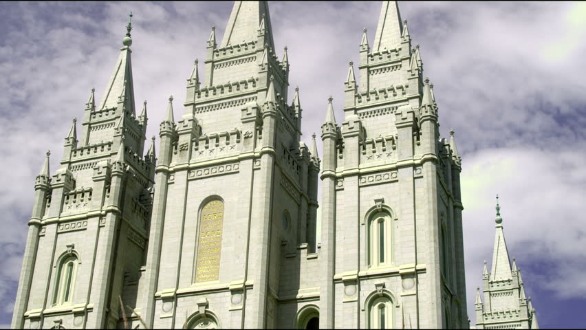 Angled tilt up the face of the Mormon temple in Salt Lake City, Utah on a cloudy day.