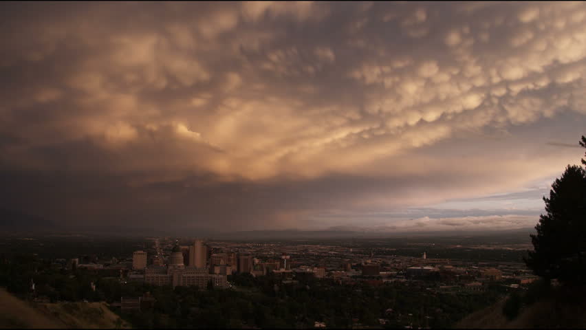 Panoramic shot of downtown Salt Lake City, Utah, including Capitol Hill, on a cloudy day at dusk.