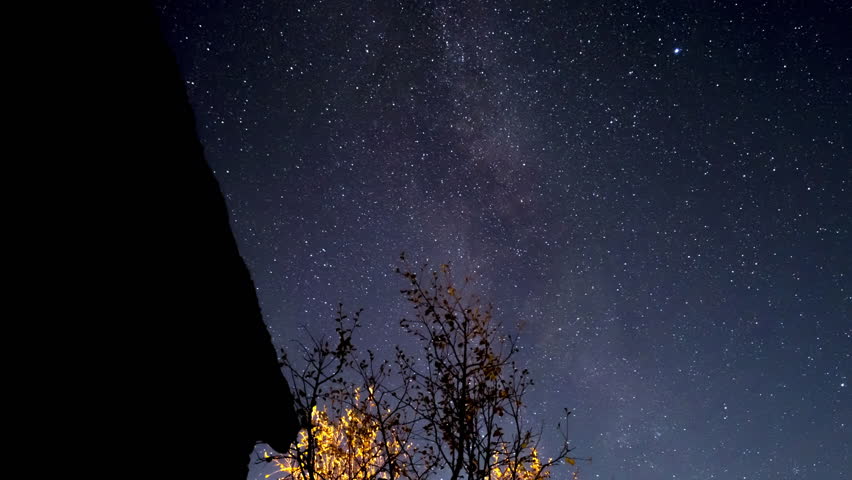 Milky way over rural autumn landscape, suprisingly many satellites moving across the night sky