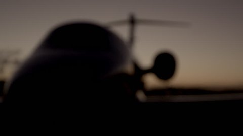 Blur in night shot of airport parked private jet (Cessna Citation IV) 