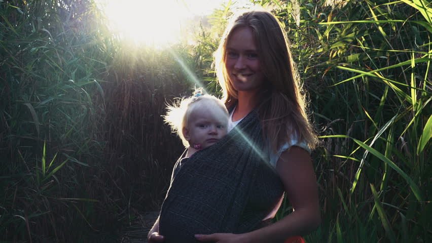 babywearing, portrait of happy baby carried in sling