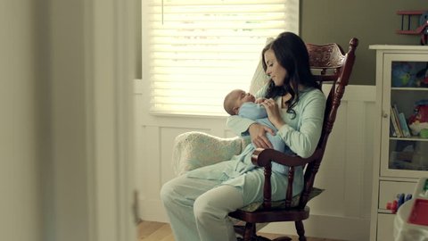 Mother with baby in rocking chair.