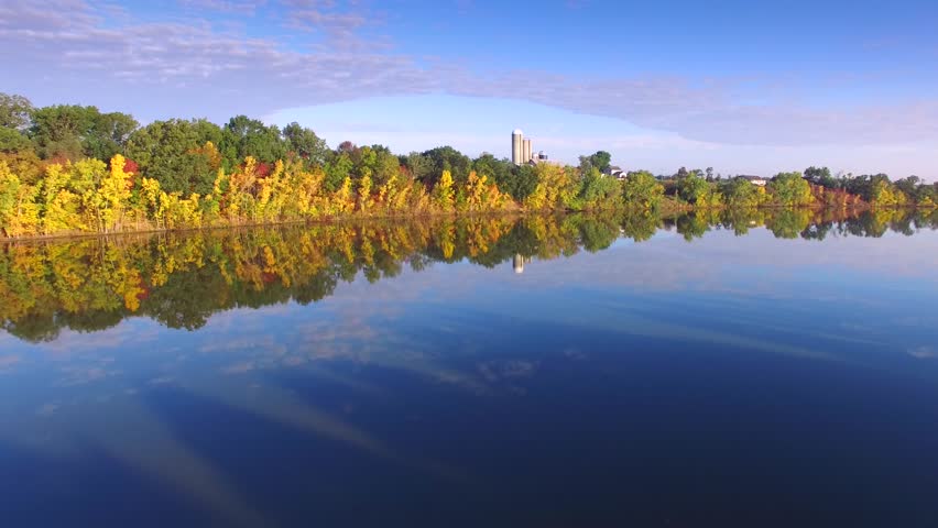 Aerial Flyover of Colorful Autumn Foliage at Picturesque Rivers Edge

