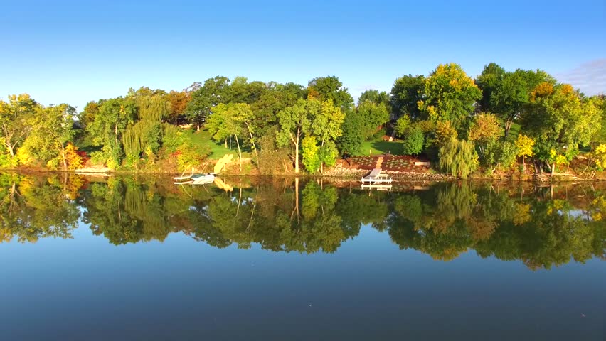 Aerial Flyby of Colorful Autumn Foliage at Picturesque Rivers Edge
