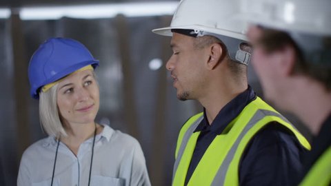 4k Confident female engineer or architect discussing construction issues with male colleagues. Shot on RED Epic.