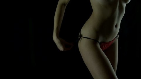 Woman in lingerie undressing her panties.