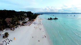 Aerial flight above white beach and Willy's Rock at Boracay Beach