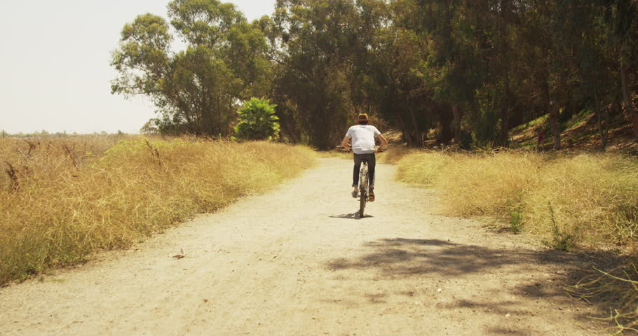 hispanic man riding bicycle on trail