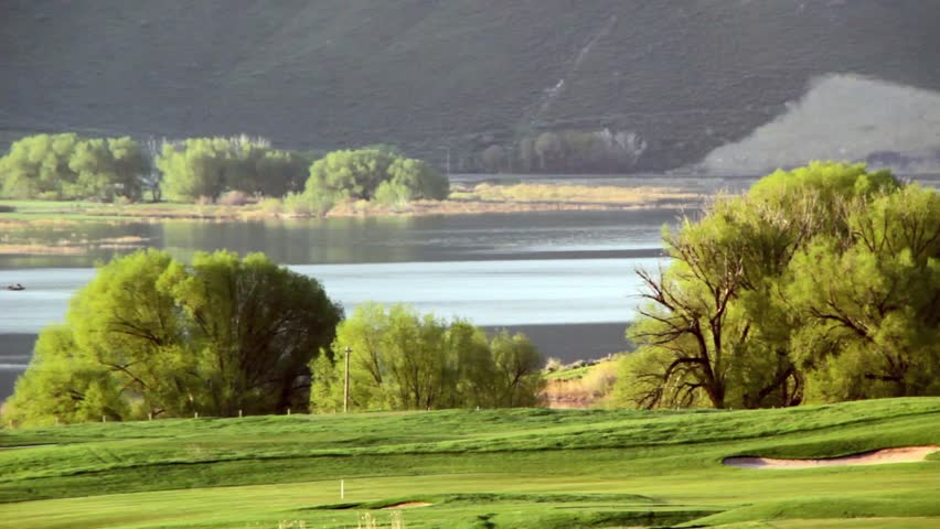 A beautiful golf course and lake in the early morning hours