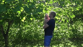 young family with little baby girl freetime in garden outdoor. Motherhood, childhood and family concept. 4K UHD video clip.