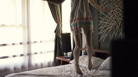 Woman legs jumping on bed, super slow motion, 240fps
