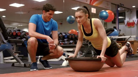 Woman doing push ups with trainer in high quality 4k format