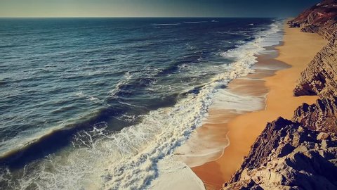 Cinemagraph loop - Ocean waves breaking on a Desert beach. Motion photo