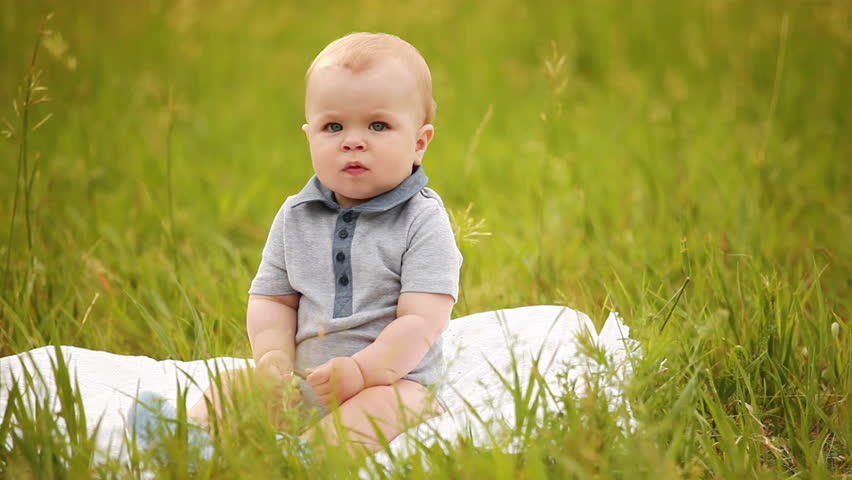 Baby boy sitting in the grass