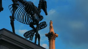 A timelapse view of the London Stock Exchange Ticker attached to the Gift Horse statue in London, UK, against a backdrop of the famous Nelson Statue - Powered by Shutterstock - Get 15% off with code: PIKWIZARD15