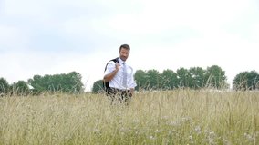 Businessman walking in wheat field