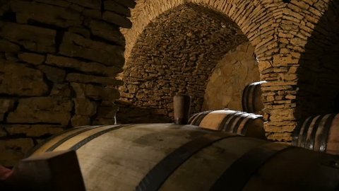 Dolly shot of the wine cellar with many wine barrels