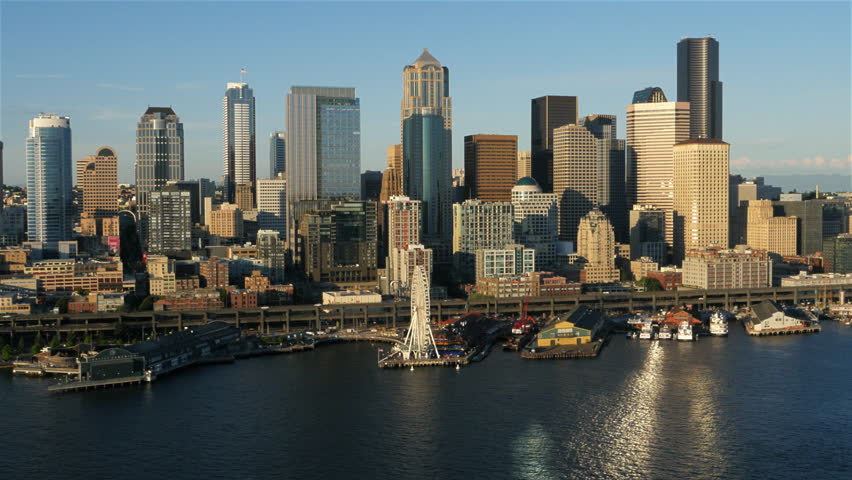 Seattle Waterfront Aerial. Low altitude view showing the buildings and skyscrapers of the business and financial disctricts in Seattle, Washington. June 2015.
