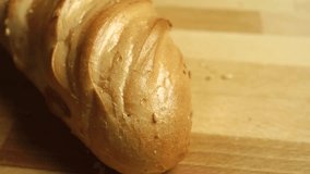 Cutting soft wheat bread, close up video