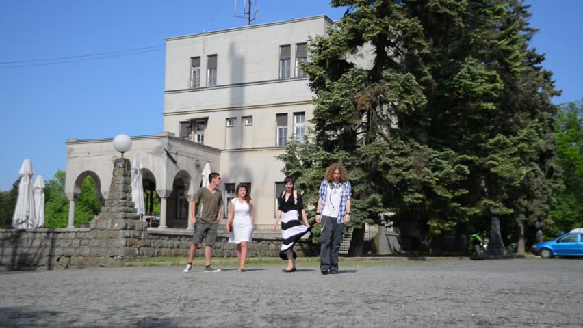 Four young people enjoy exploring new town. 
