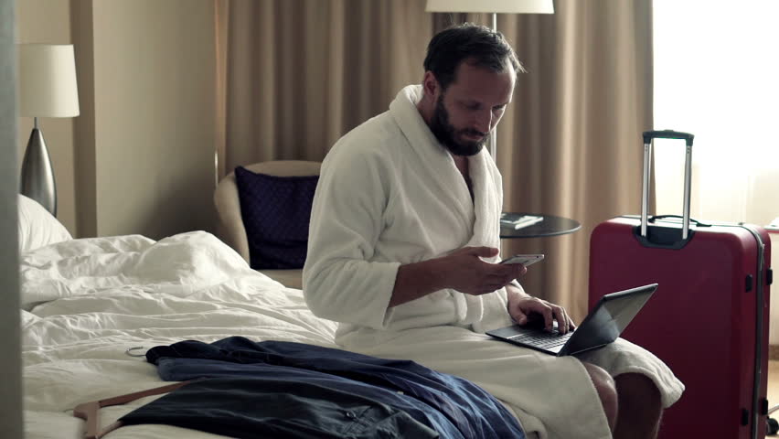 Young businessman working with laptop and smartphone in hotel room
 | Shutterstock HD Video #12157631