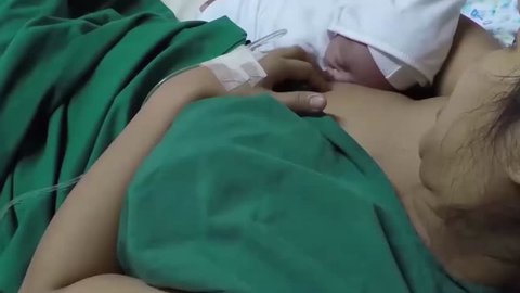 A newly born infant roomed and breast feed by mother in a hospital