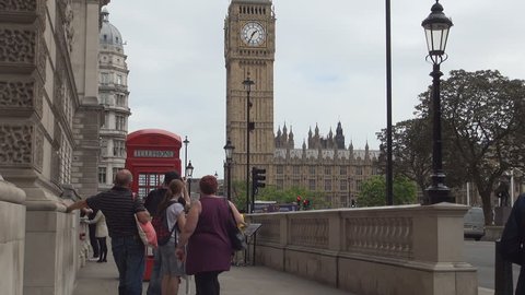 UNITED KINGDOM, LONDON, JUNE 2015 : Tourists Wait Red Phone Booth London View Big Ben Westminster Palace Street