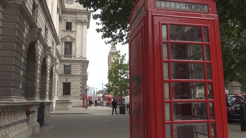 UNITED KINGDOM, LONDON, JUNE 2015 : Red Phone Booth London View Tourist Sidewalk Big Ben Westminster Palace Street 
