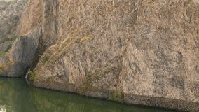 Cliffside Lake with Flies. A great piece of stock footage filmed in 4k definition, perfect for film, tv, documentaries, reality TV, trailers, infomercials and more!