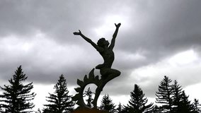 Dancing Statue with Dark Clouds. A great piece of stock footage filmed in 4k definition, perfect for film, tv, documentaries, reality TV, trailers, infomercials and more!