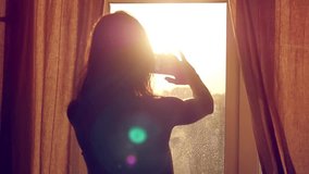 Young Girl Taking Photos Of City With blurred architectures on Mobile Smart Phone at home window in slow motion - Powered by Shutterstock - Get 15% off with code: PIKWIZARD15