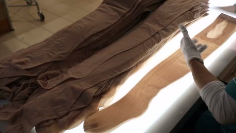 On the production line, worker package new women's pantyhose.