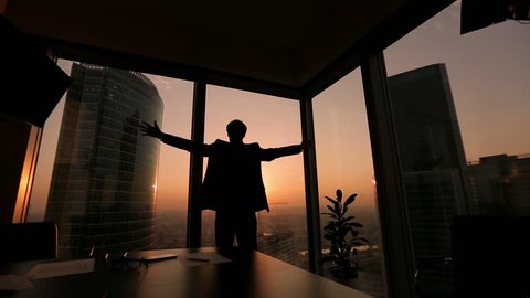 businessman looking out the window in a contemplative way, Dolly shot, sunset, silhouette