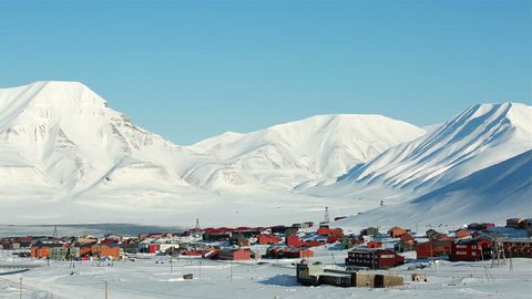 LONGYEARBYEN, SPITSBERGEN, NORWAY - 03 APRIL, 2015: Small town among snow-capped mountains of the Norwegian archipelago of Svalbard in early spring.