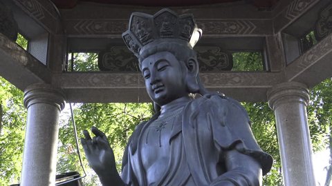 Statue of Bodhisattva Avalokitesvara with hand gestures or mudras. Kwan Yin, Quan Yin or Guanyin is the Bodhisattva of Compassion, Ontario, Canada