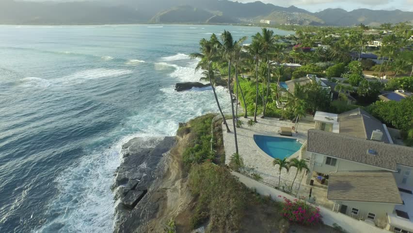 (Aerial Shot) Panning Around Ocean Front Property with Palm Trees and Ocean. Honolulu, Hawaii at Chinawall in Koko Kai Beach Park